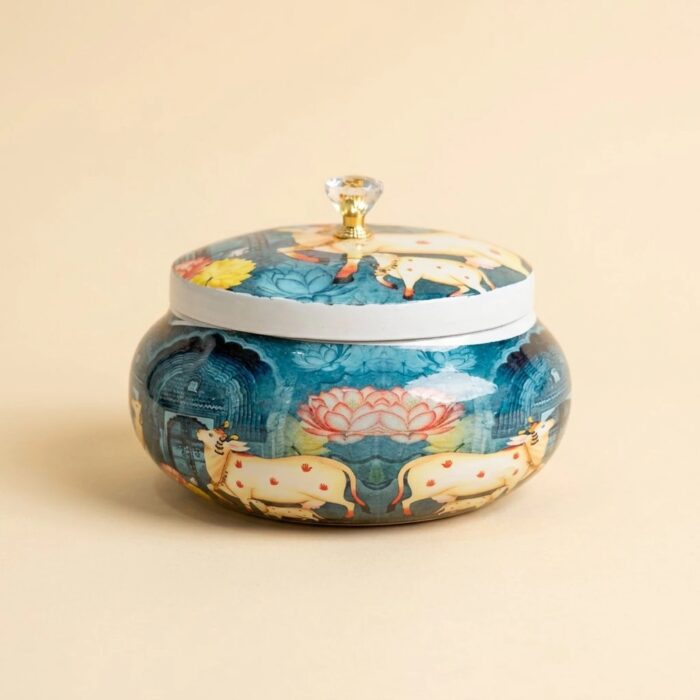 Pichwai cow dry fruit jar with crystal knob lid on beige background