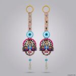 Pair of peacock Shubh Labh door hangings in turquoise, hot pink and gold zari with beaded evil eye and pearl latkans
