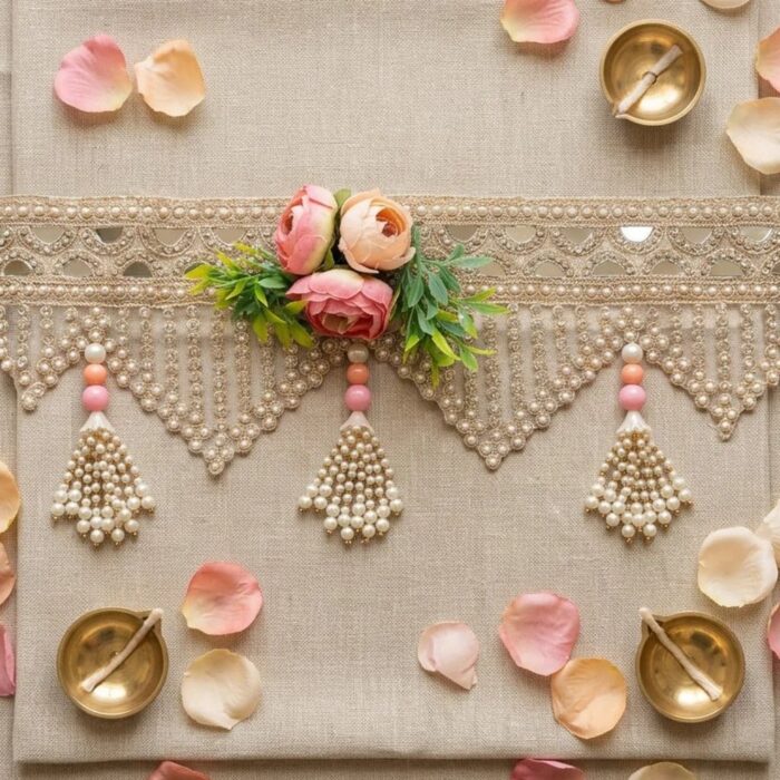 Blush rose mirror toran flat lay with diyas — gold mirror lace, artificial pink roses and faux pearl tassels for wedding door decor