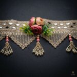 Close view of gold mirror toran on black — blush rose cluster, triangular pearl and crystal fringe and pearl tassel with pink beads