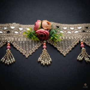 Close view of gold mirror toran on black — blush rose cluster, triangular pearl and crystal fringe and pearl tassel with pink beads