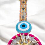 Close up of the zari gota patti with beaded evil eye on the shubh labh hanging