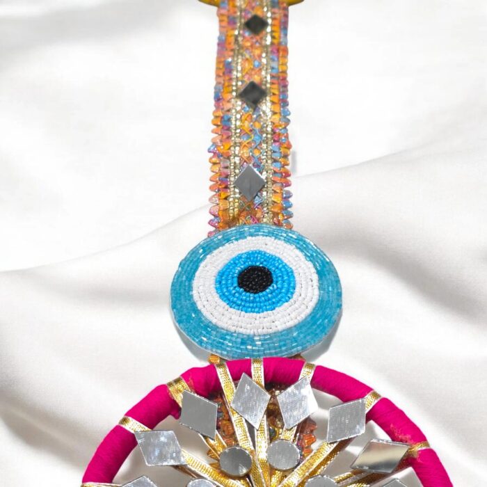 Close up of the zari gota patti with beaded evil eye on the shubh labh hanging