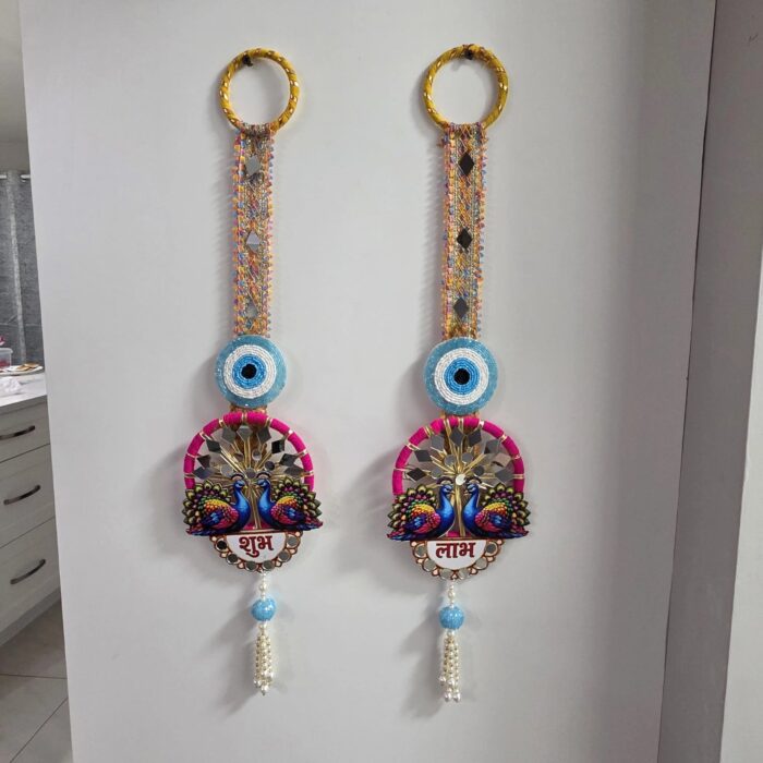 Peacock Shubh Labh pair styled on a mantel with marigolds and lit diyas for Diwali