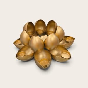 Matte gold lotus diya stand, two tiers of petal candle cups, unlit on white background