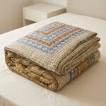 Folded cotton quilt on a king size bed