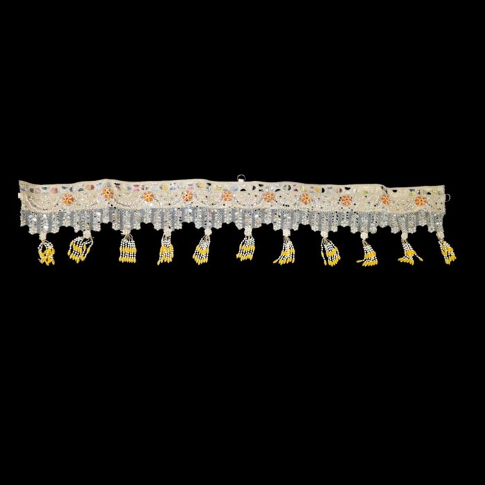 Close-up of golden mirror toran embroidery — real glass sheesha, gold zari, faux pearls and hand-beaded red and yellow flower with pearl and yellow tassel
