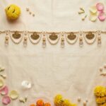 Pearl toran styled with marigold flowers rose petals and jasmine for Diwali pooja door decoration