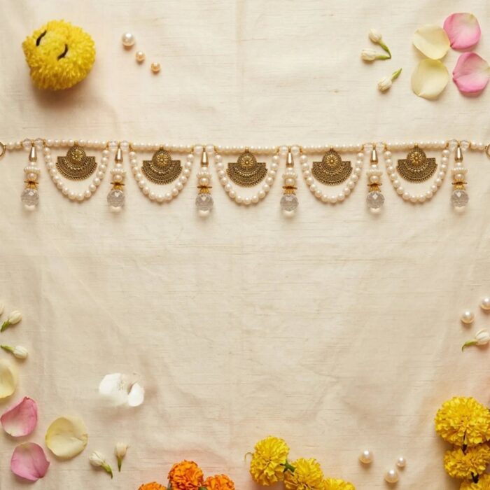 Pearl toran styled with marigold flowers rose petals and jasmine for Diwali pooja door decoration