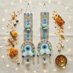 Shubh Labh pair flat-lay with marigolds, cinnamon, brass diya and fairy lights for Diwali decoration