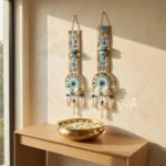 Gold zari Shubh Labh band with hand-set blue flowers, pearl trim and hanging pearl latkan tassels