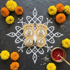 Lakshmi charan paduka laid on kolam on diwali decor